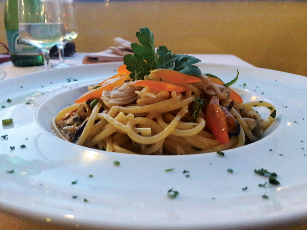 Homemade Spaghetti with seafood , yellow cherry tomatoes and green chilies zi carmela